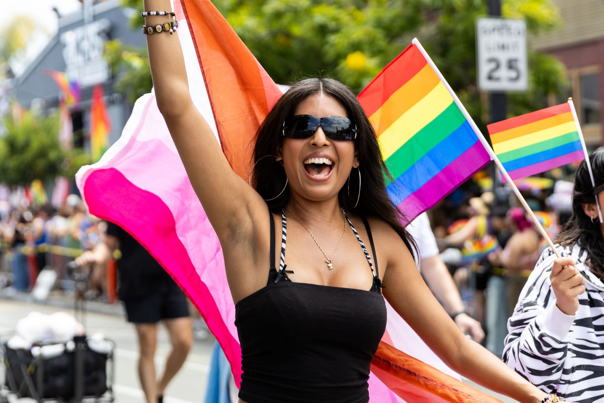 A person holds a lesbian pride flag in a parade