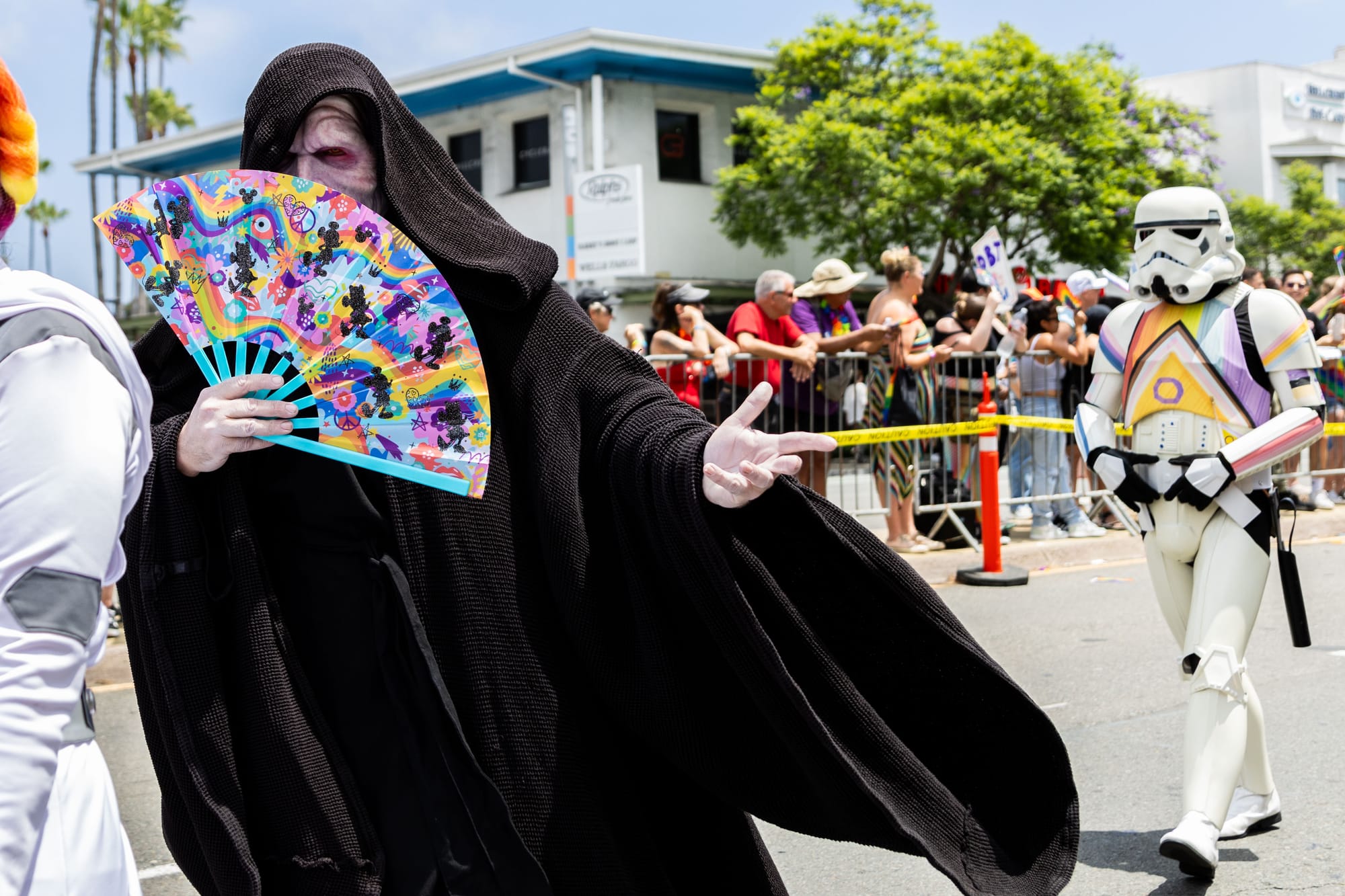 A person dressed in a sith lord costume with a stormtrooper behind them