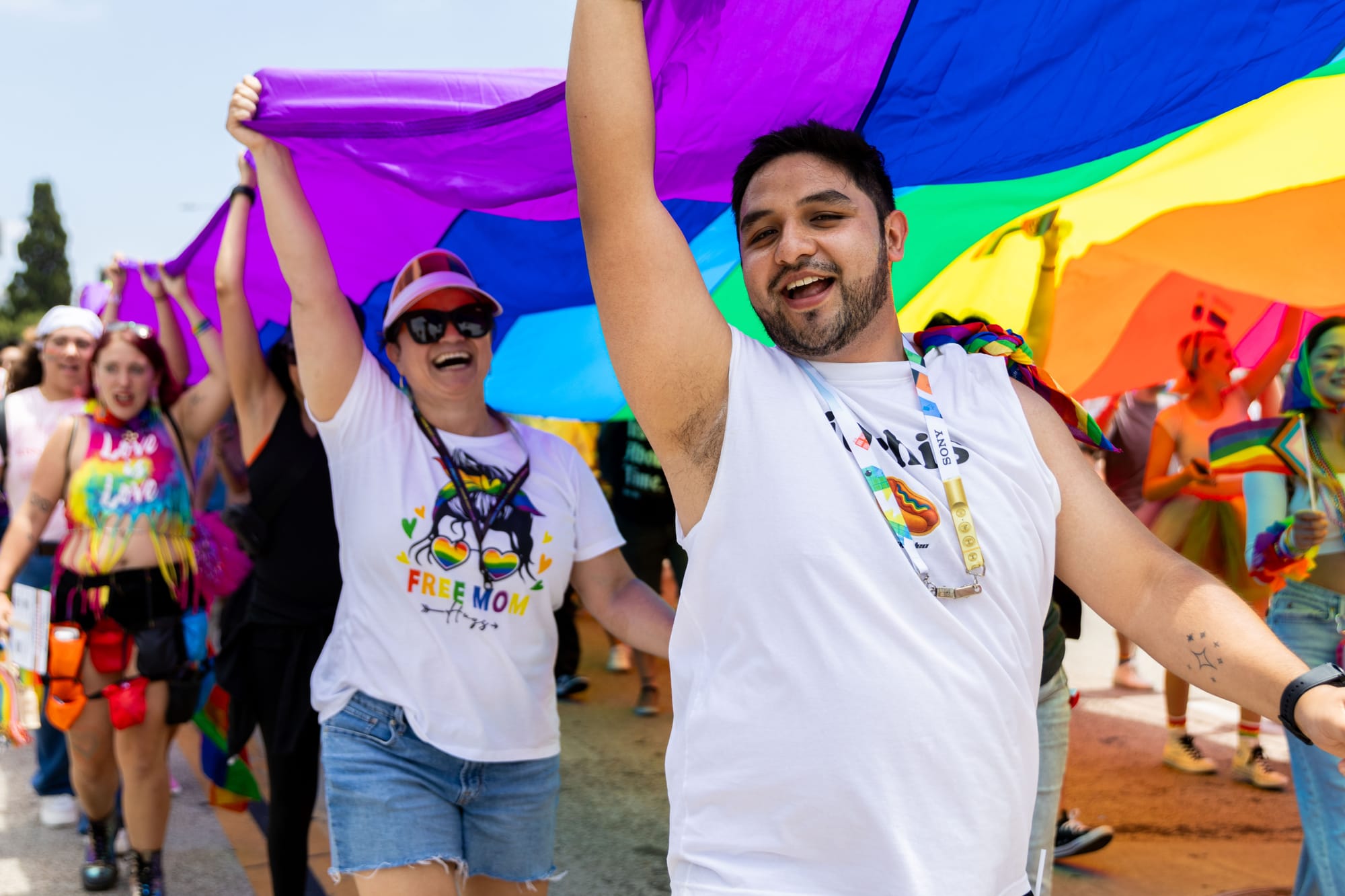 People hold a giant rainbow flag in the street