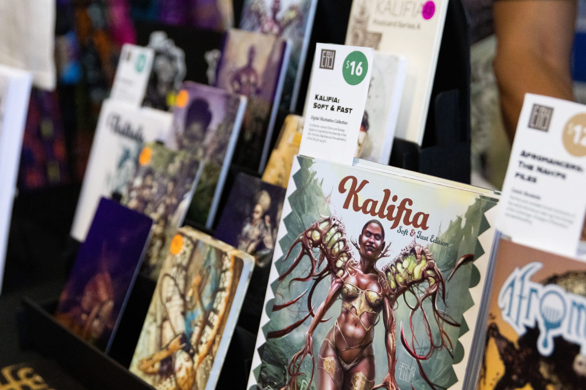 Comic books sit on a table in a display holder