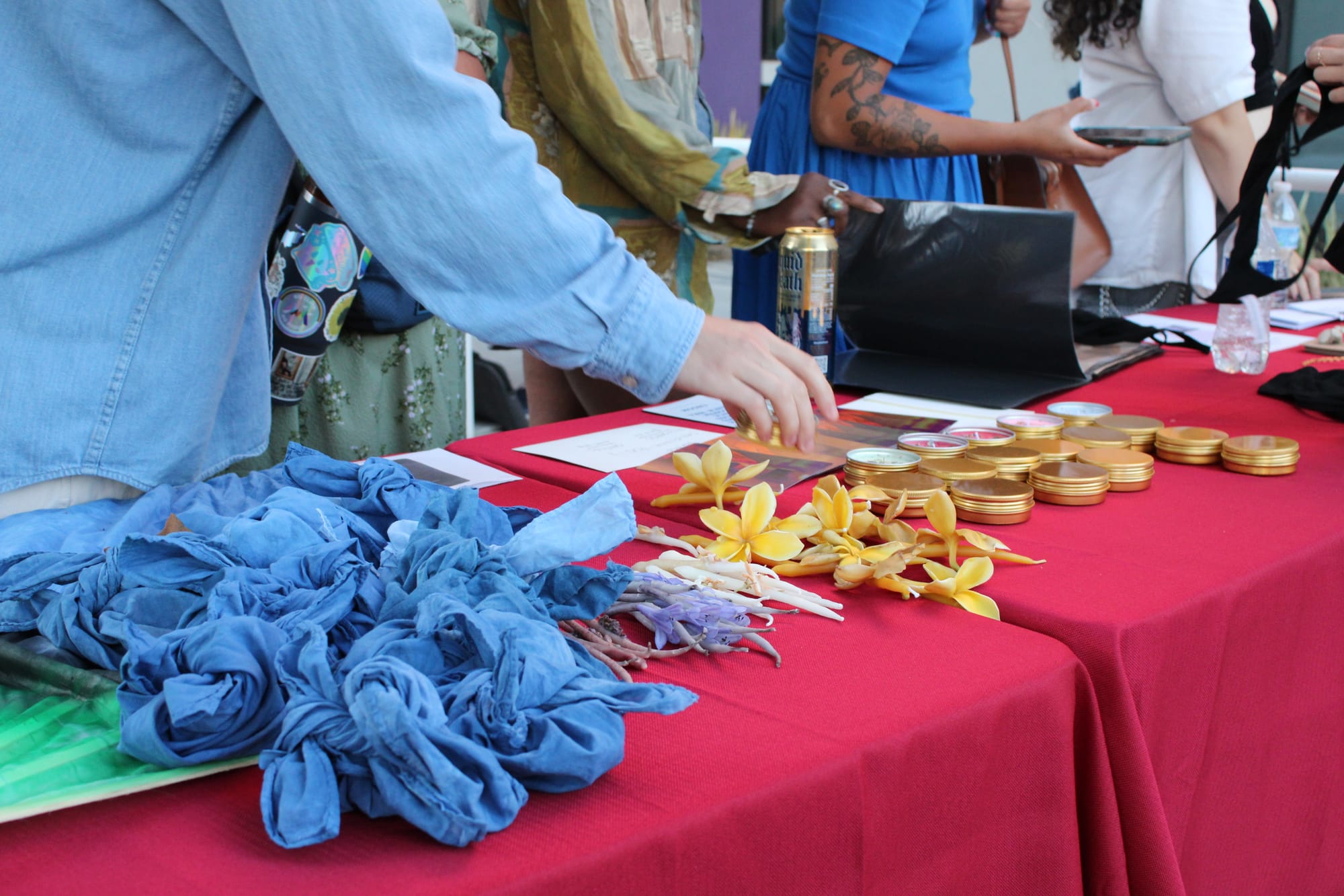 Close up of people's hands browsing items on a table