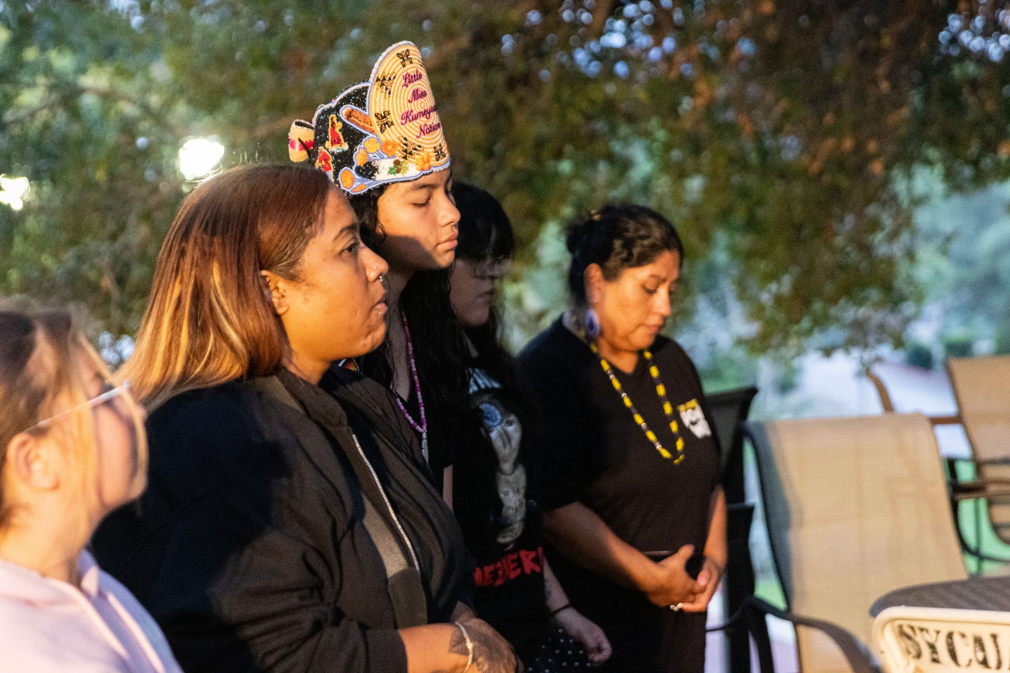 Women stand in a line while dancing
