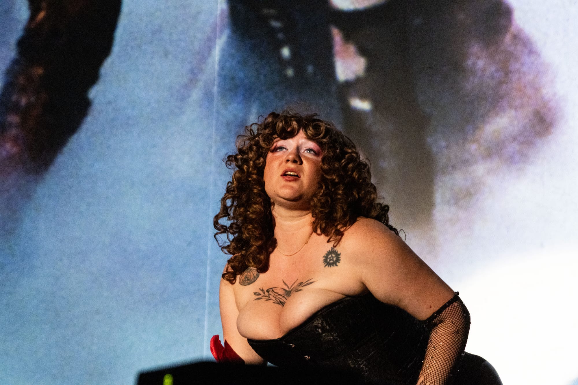A person acts in front of a movie scree
