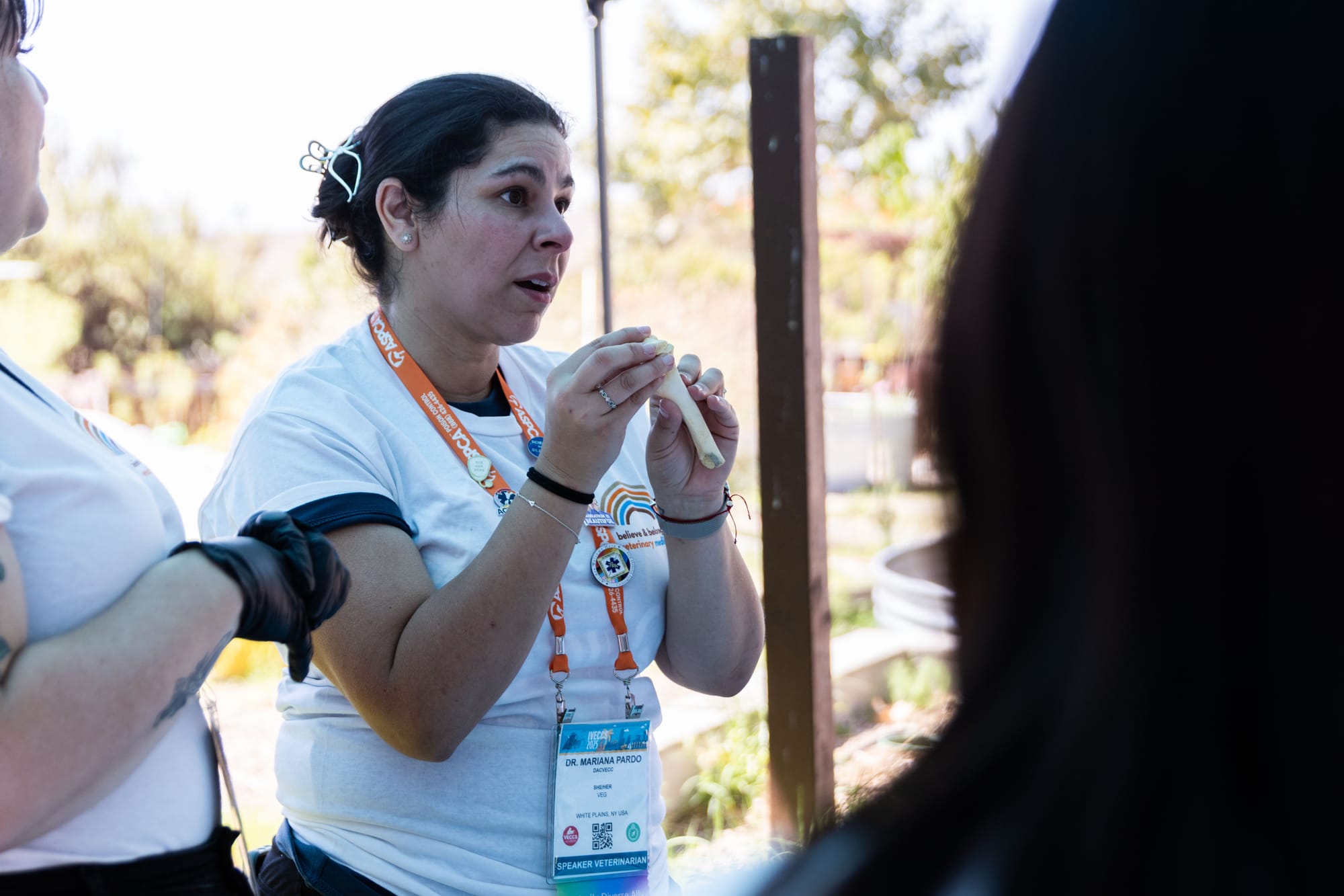 A woman holds an animal bone during a demonstration