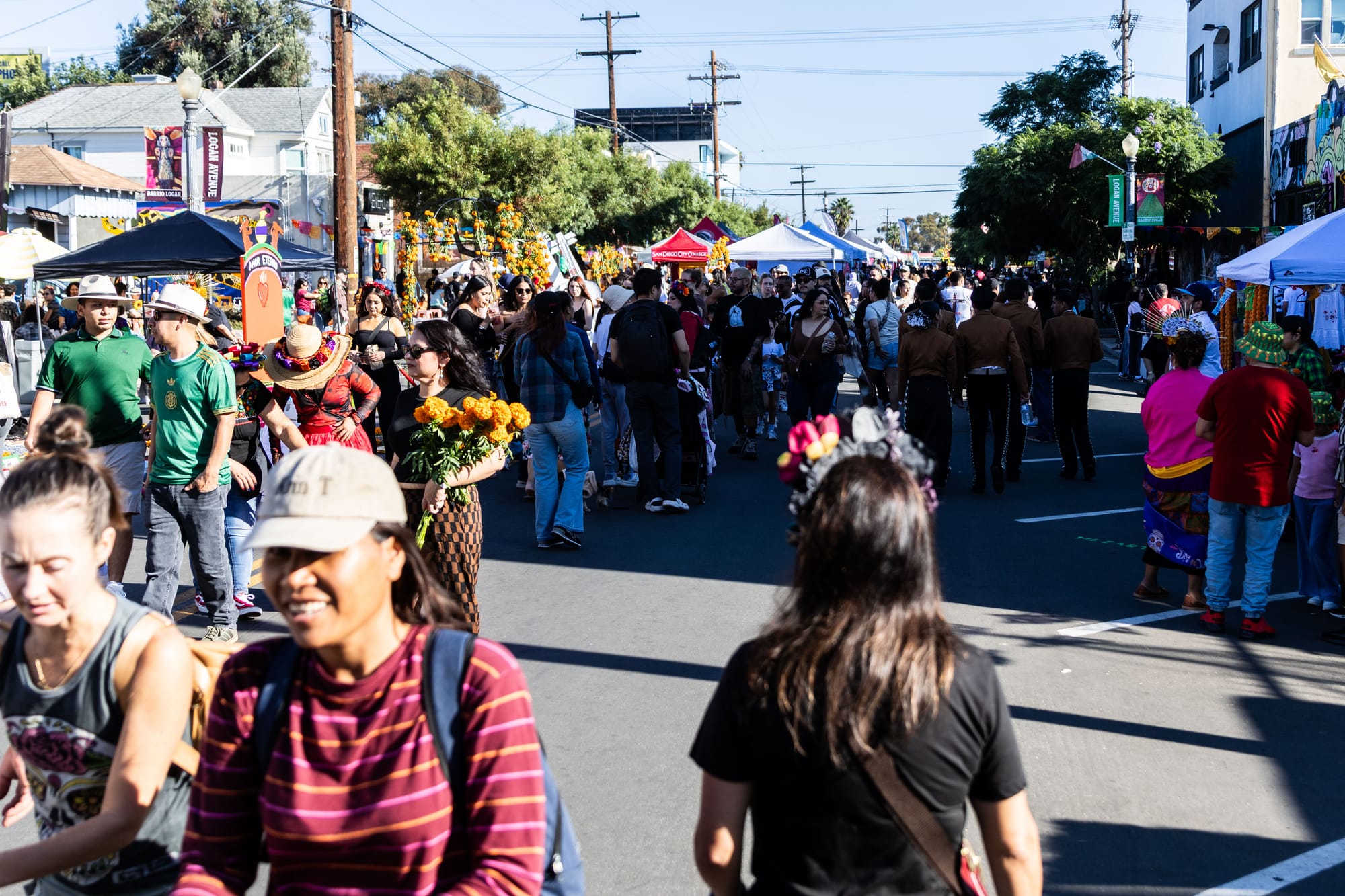 Dozens of people walk around on the street.