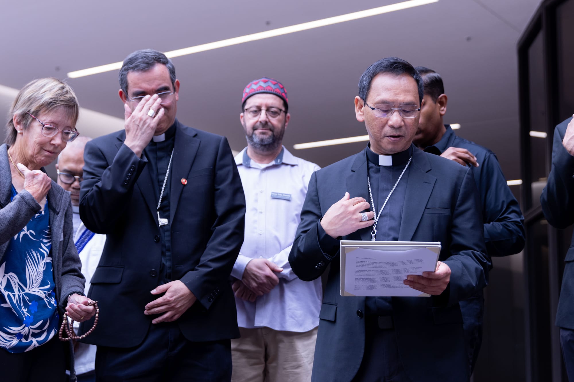 A group of faith leaders stand outside together
