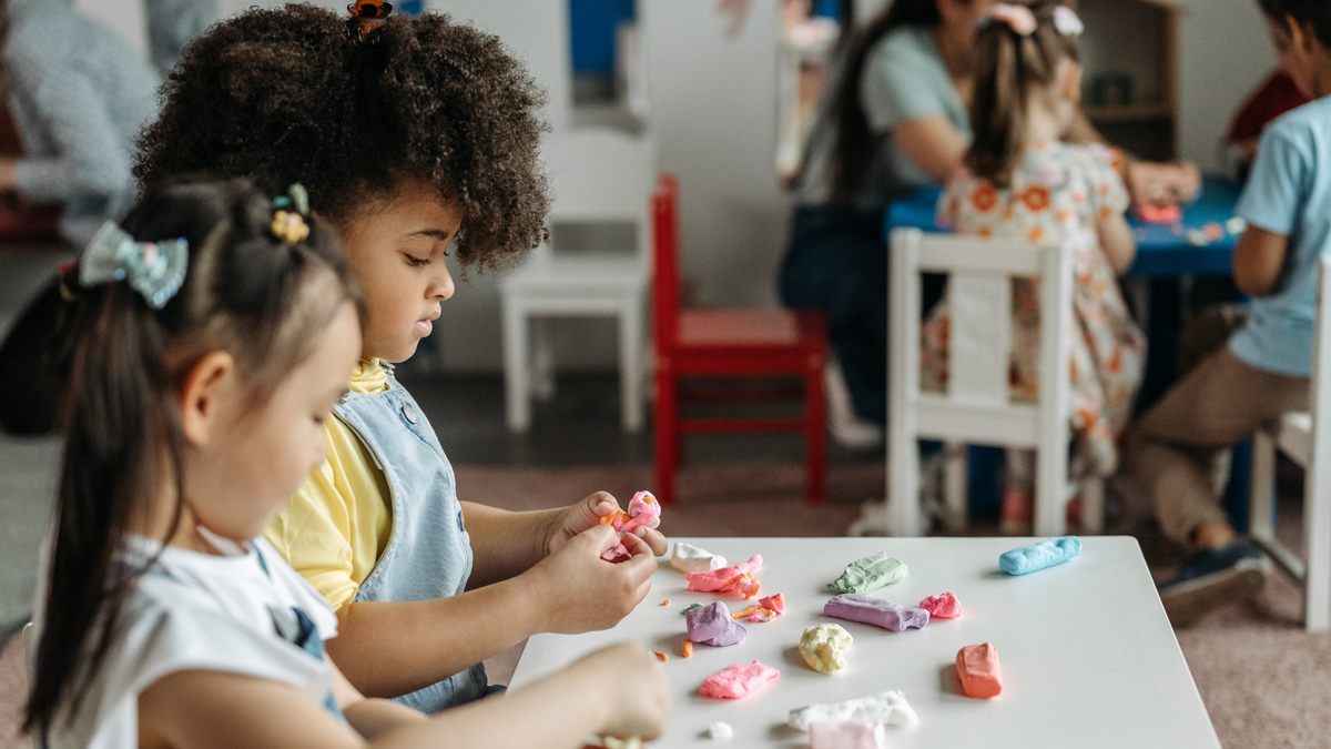 Two children mold shapes with playdough