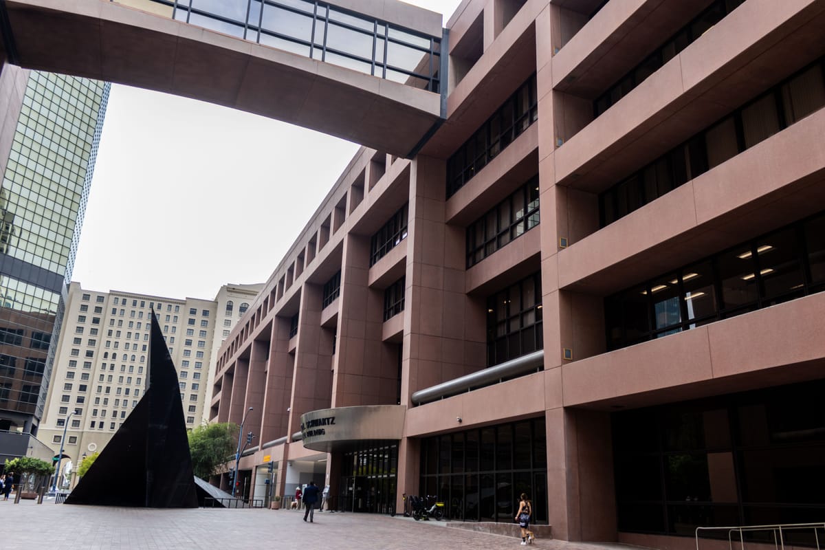 A court building with other buildings behind it 