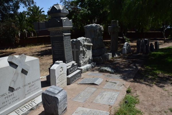 Gravestones stand in a corner