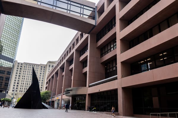 A court building with other buildings behind it 
