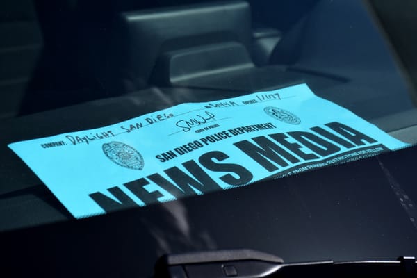 Picture blue paper placard with the words “San Diego Police Department News Media”