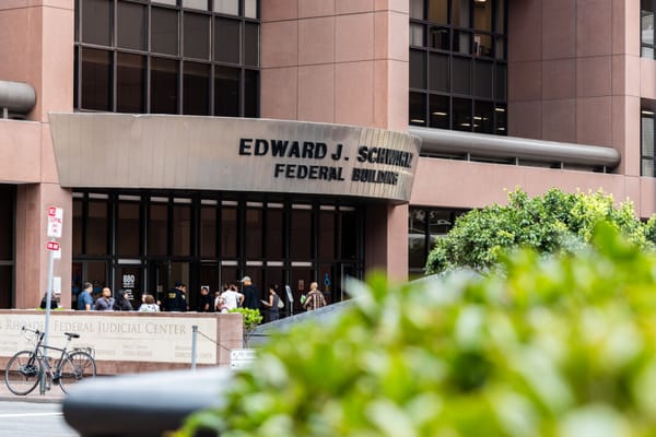 A large brown building next to a plaza