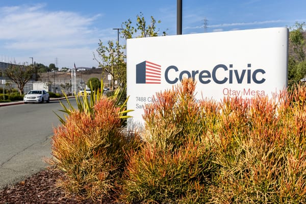 A sign surrounded by bushes reads CoreCivic Otay Mesa Detention Center